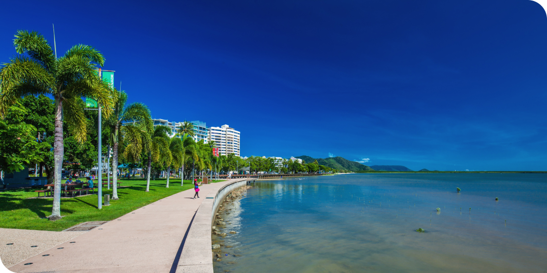 The Esplanade in Cairns with palm trees and the ocean, Queensland, Australia